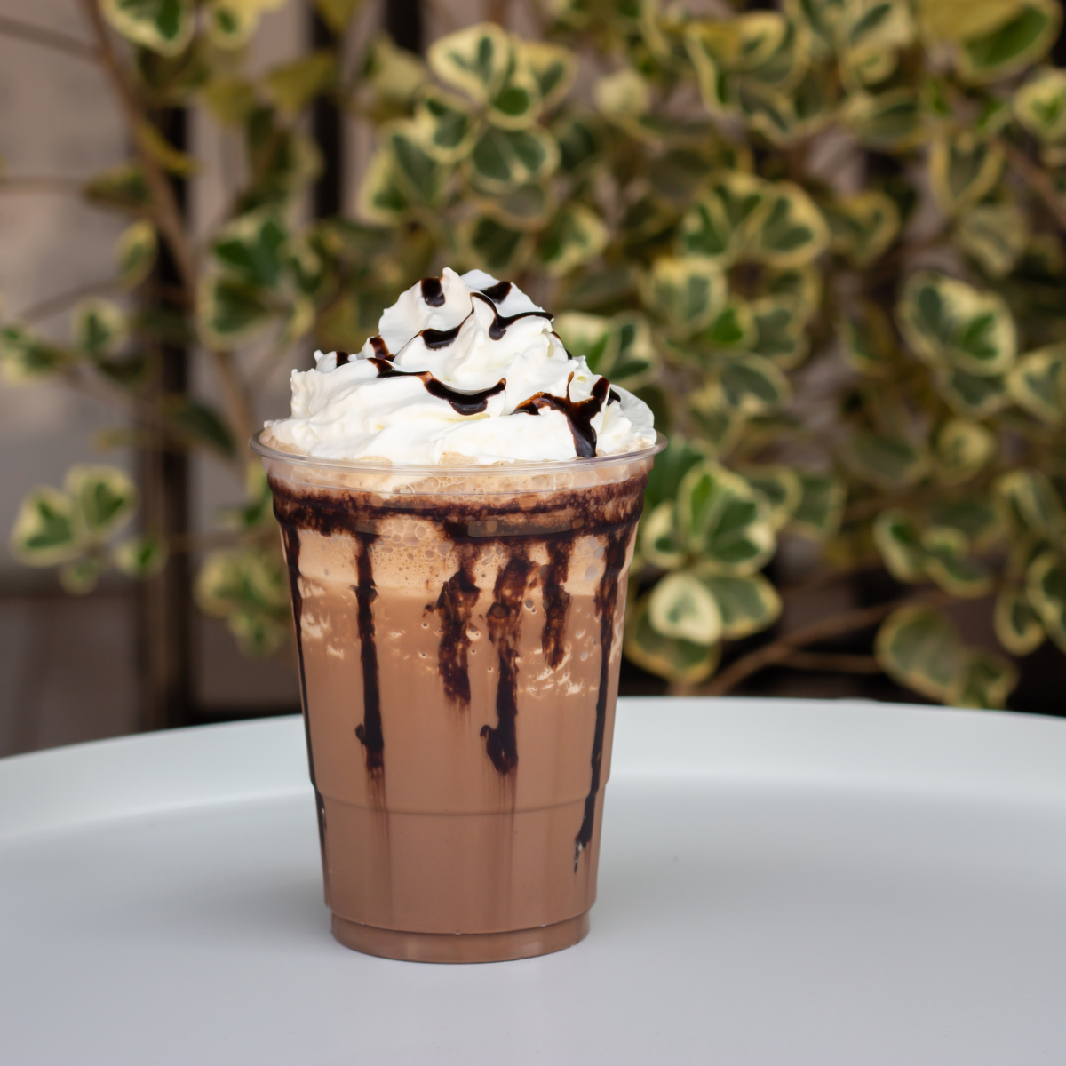 chocolate frappe with whip cream sat on a table