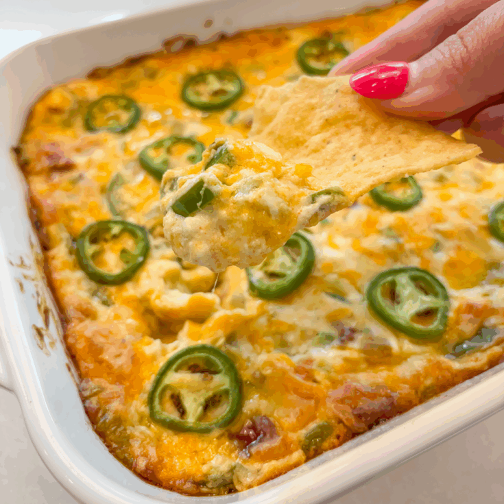 close up of jalapeno popper dip on a tortilla chip