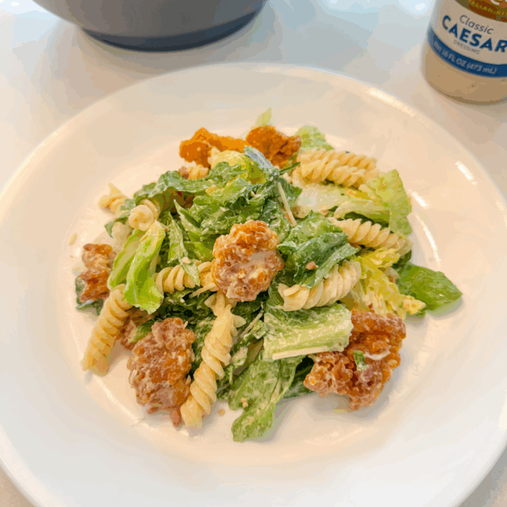 easy chicken caesar pasta salad on a white plate