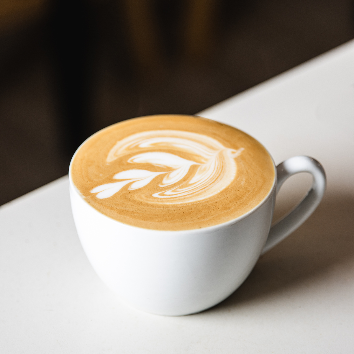 latte with latte art in a white mug