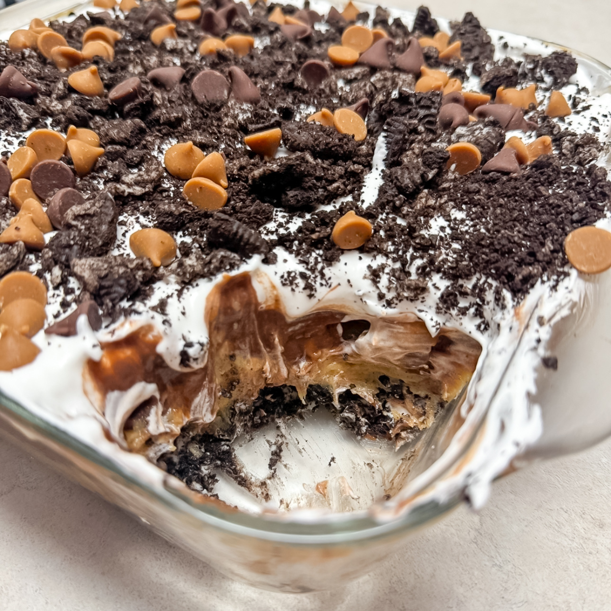 peanut butter oreo pie in a dish with a piece missing