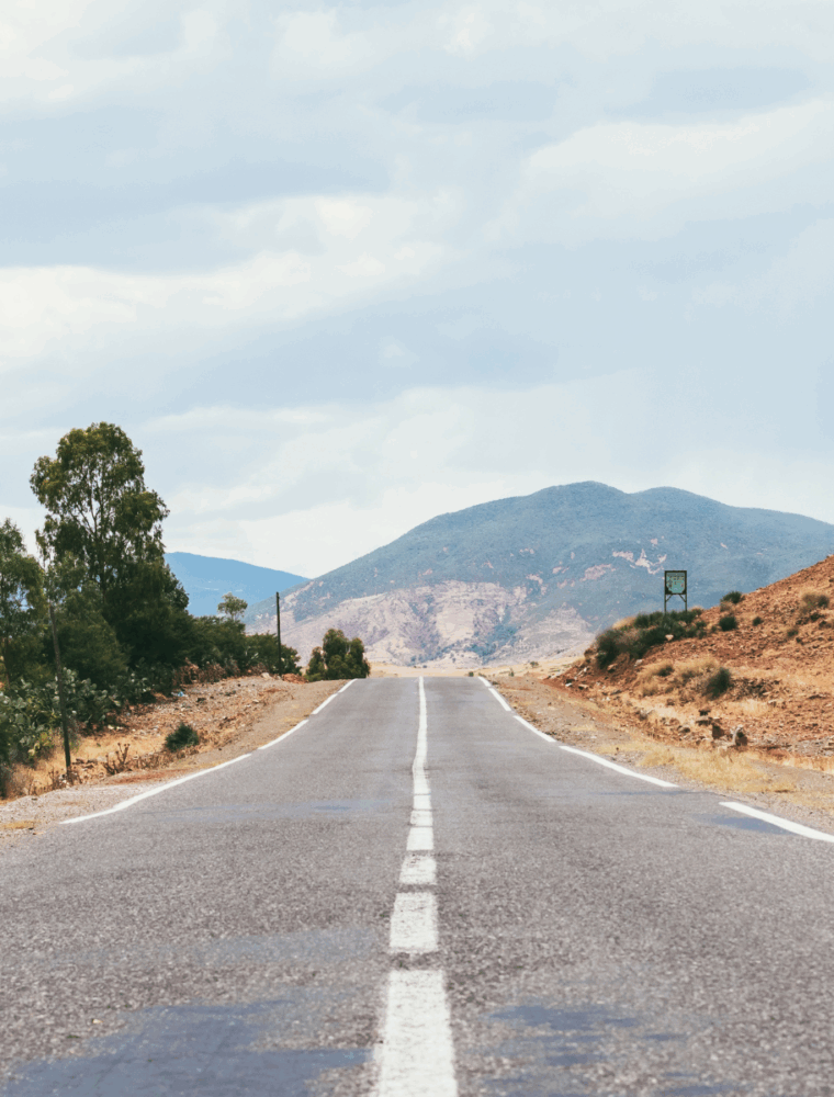 road with mountains in the background