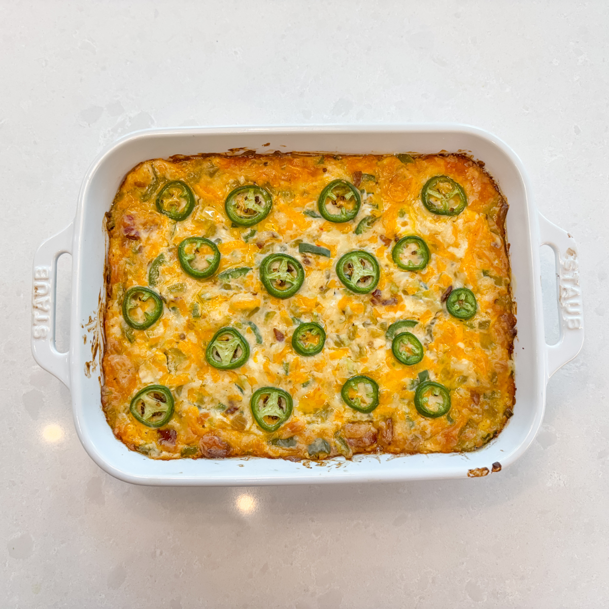 top view of baked jalapeno popper dip in a white dish