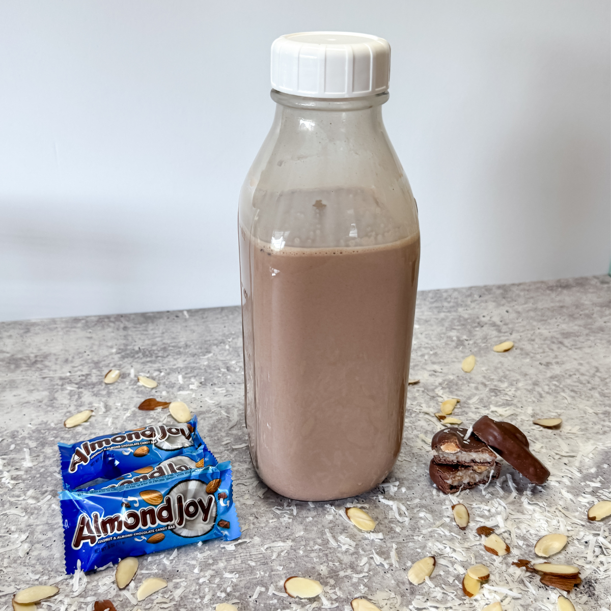 close up of almond joy coffee creamer in clear glass
