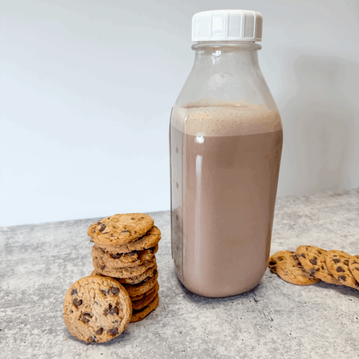 cookies stacked next to a jar of coffee creamer
