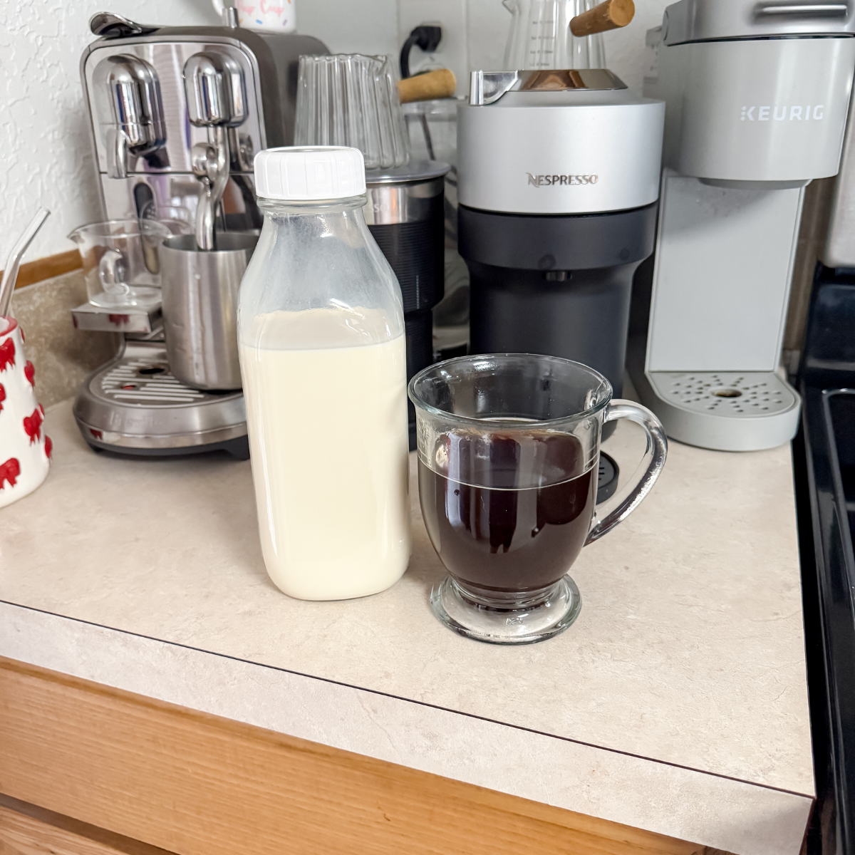 cup of coffee next to a jar of sweet and creamy coffee creamer
