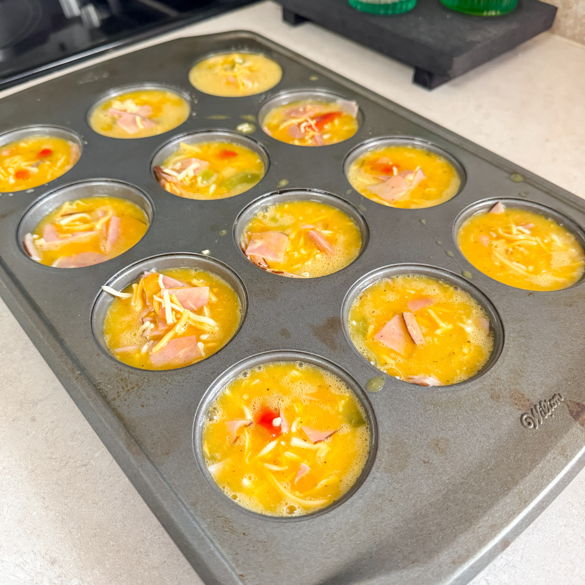 egg muffins in the muffin pan before being baked