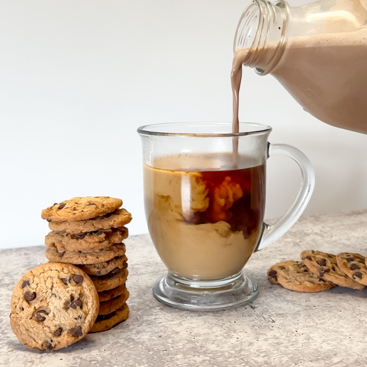 pouring chocolate chip cookie creamer into coffee