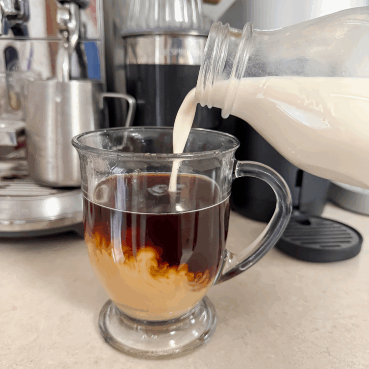 pouring sweet and creamy coffee creamer into coffee