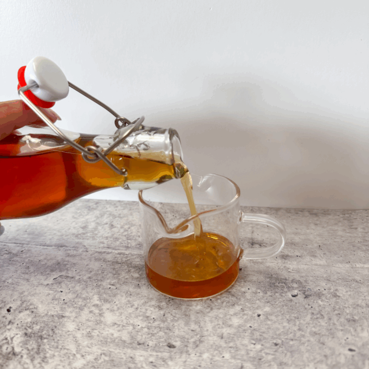 pouring vanilla syrup into a little cup