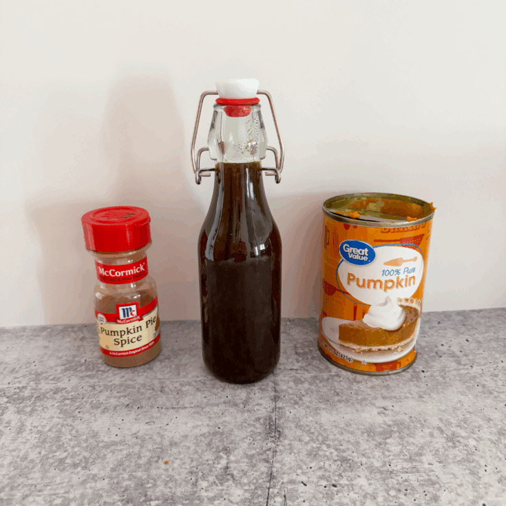 bottle of pumpkin pie spice coffee syrup next to canned pumpkin