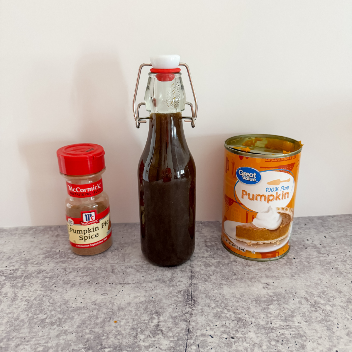 bottle of pumpkin pie spice coffee syrup next to canned pumpkin