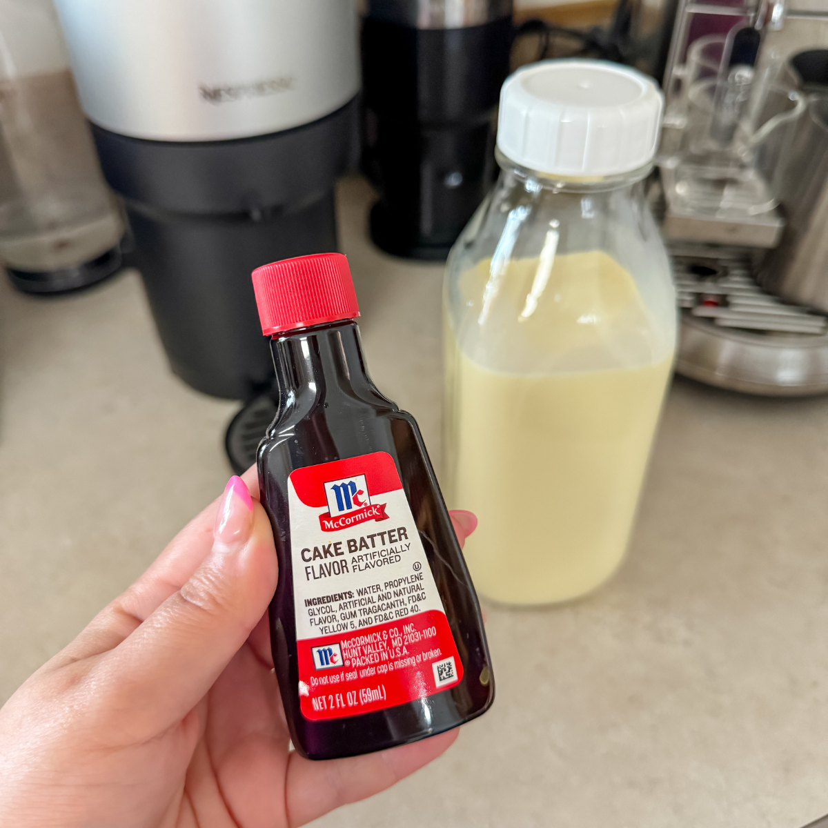 close up of cake batter extract in front of a jar of coffee creamer